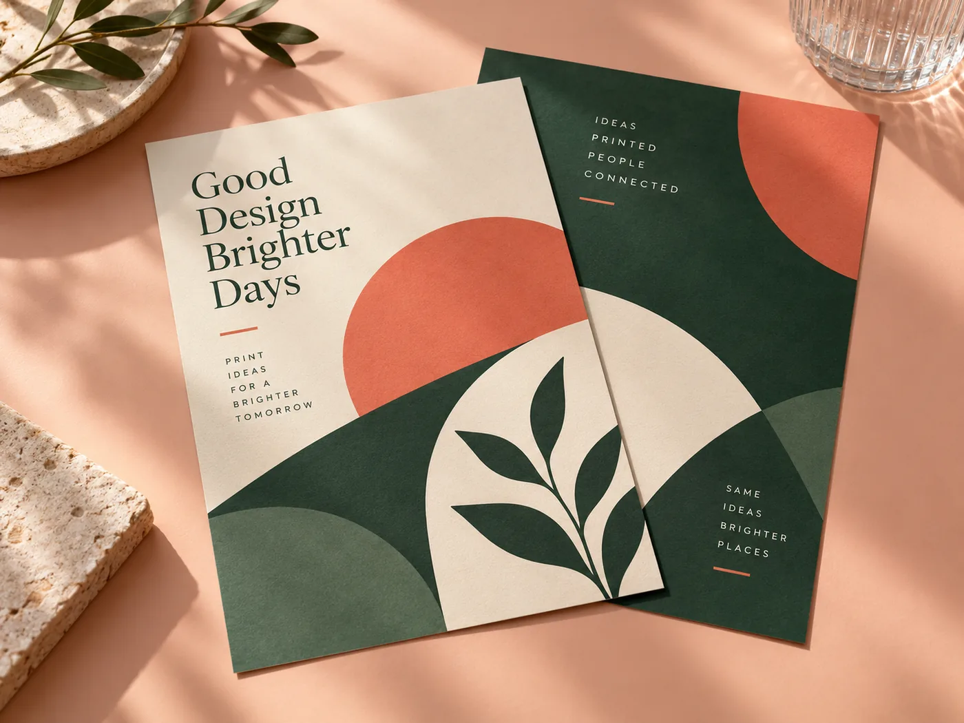 Coral and forest green marketing flyers on a peach surface